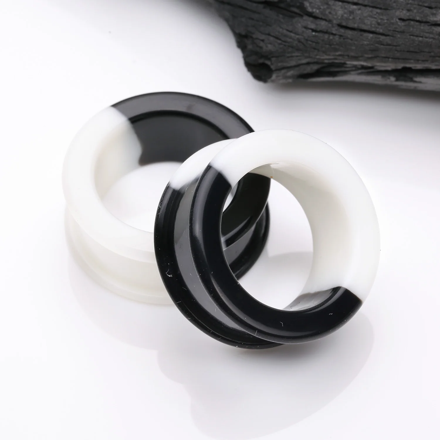 A Pair of Black and White Duo Tone Flexible Silicone Double Flared Tunnel Plug - Image 2